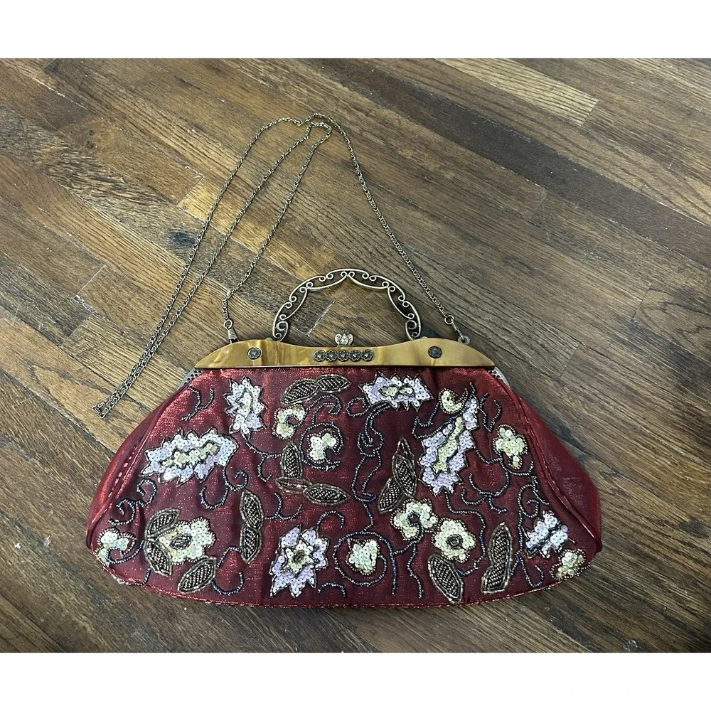 Vintage intricate beaded floral designs, a brass kiss-lock frame, and a chain